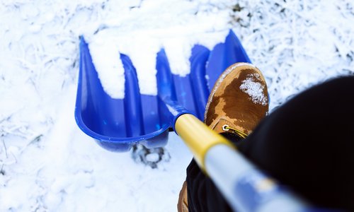 Worker on the street ,shoveling snow